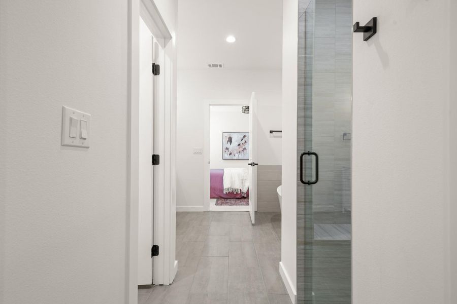 Hallway with recessed lighting and light tile patterned floors