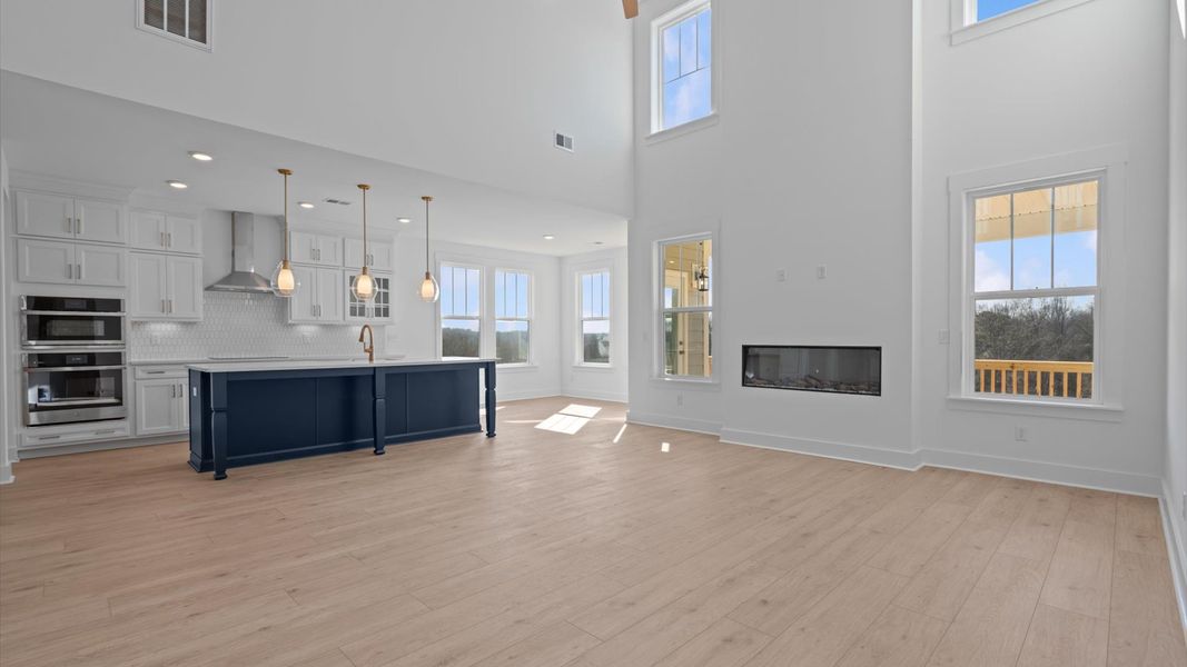 Highly skilled craftsmanship and modern elegance meet in this family room with soaring ceilings