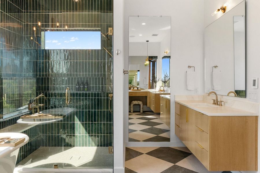 Glass-enclosed shower with vertical teal tile surround and a rectangular window