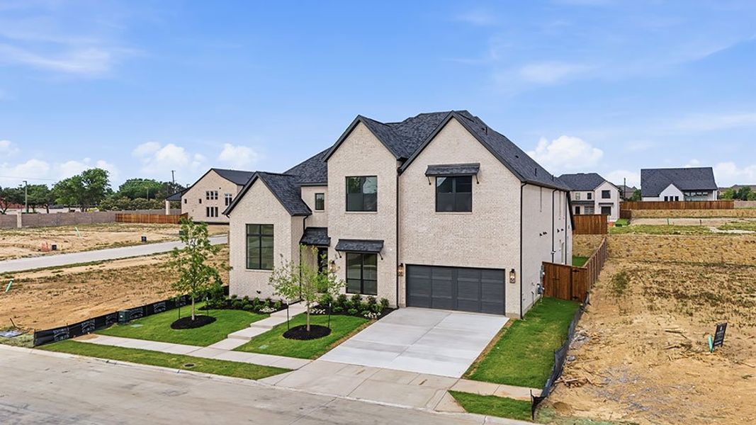 Front exterior of a new home in Custer Ridge Estates, Allen, TX, highlighting curb appeal (Image 30). Front exterior of a new home in Custer Ridge Estates, Allen, TX, highlighting curb appeal (Image 30).