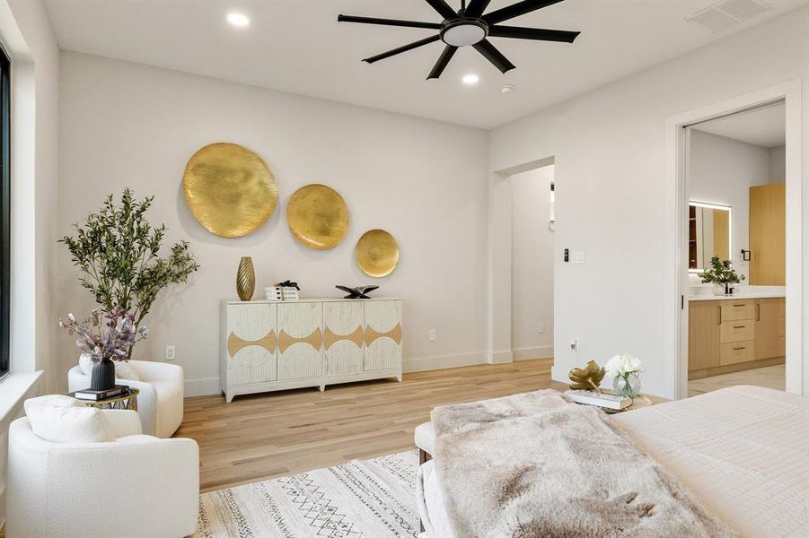 Bedroom with hardwood / wood-style flooring, ensuite bathroom, and ceiling fan