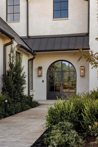 View of exterior entry featuring french doors and stucco siding View of exterior entry featuring french doors and stucco siding