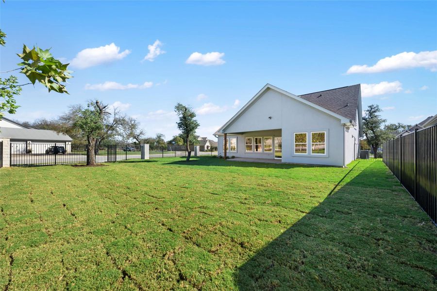 Fenced backyard with a patio
