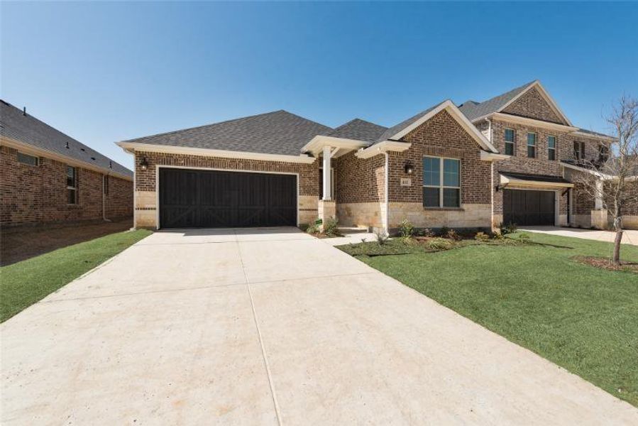 Front exterior of a new home in Spiritas Ranch, Little Elm, TX, highlighting curb appeal (Image 16).