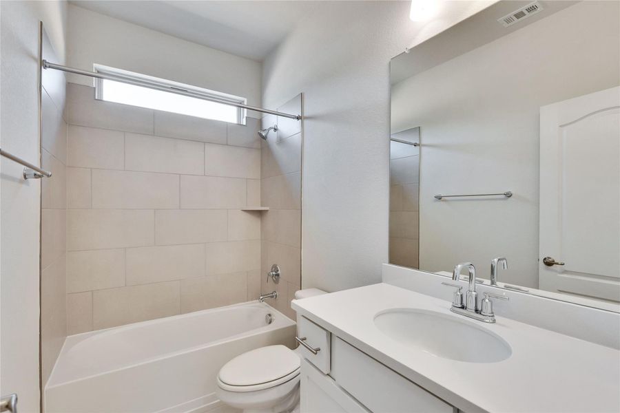 Bathroom featuring toilet, bathtub / shower combination, and vanity Bathroom featuring toilet, bathtub / shower combination, and vanity