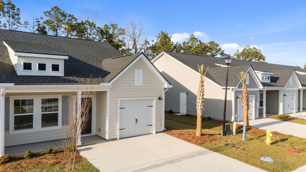 Front exterior of a new home in Blue Heron Retreat, Little River, SC, highlighting curb appeal (Image 17). Front exterior of a new home in Blue Heron Retreat, Little River, SC, highlighting curb appeal (Image 17).