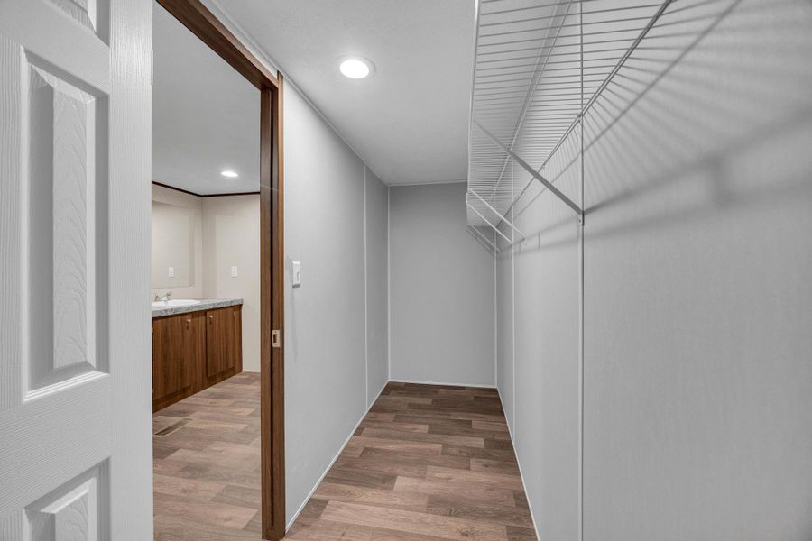 Walk in closet featuring light wood-style floors