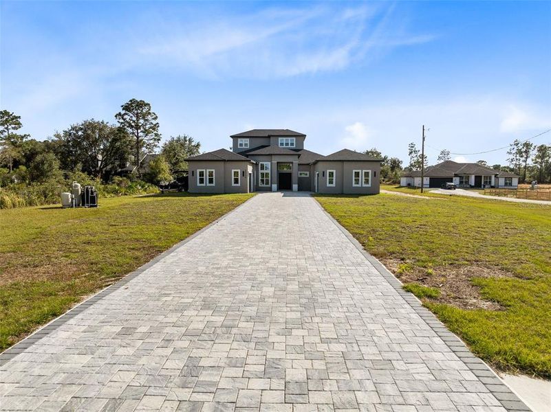 A paver driveway welcomes you home.