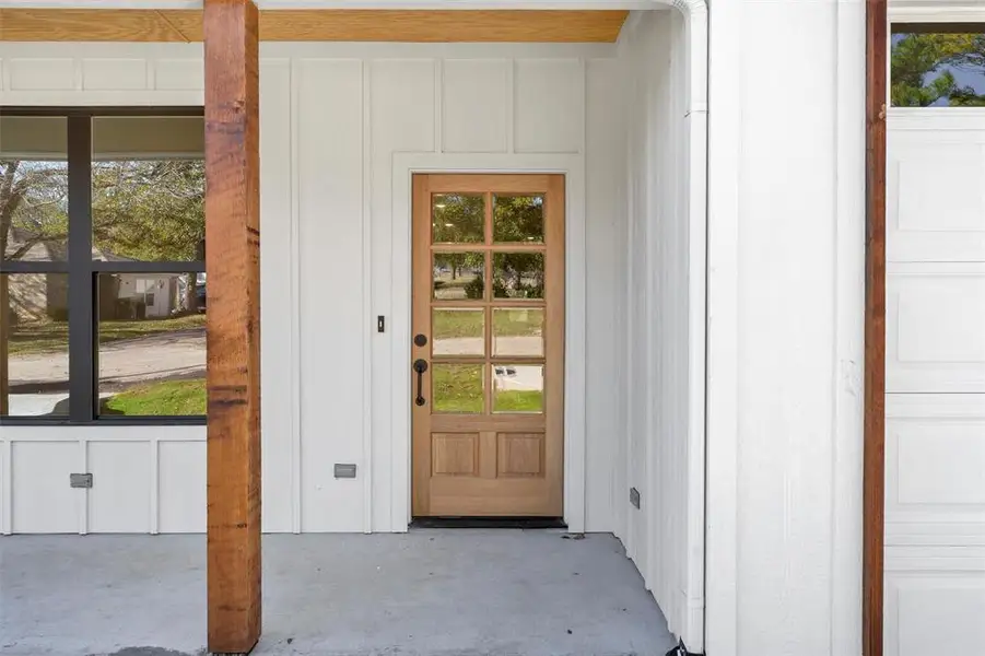 Property entrance featuring board and batten siding