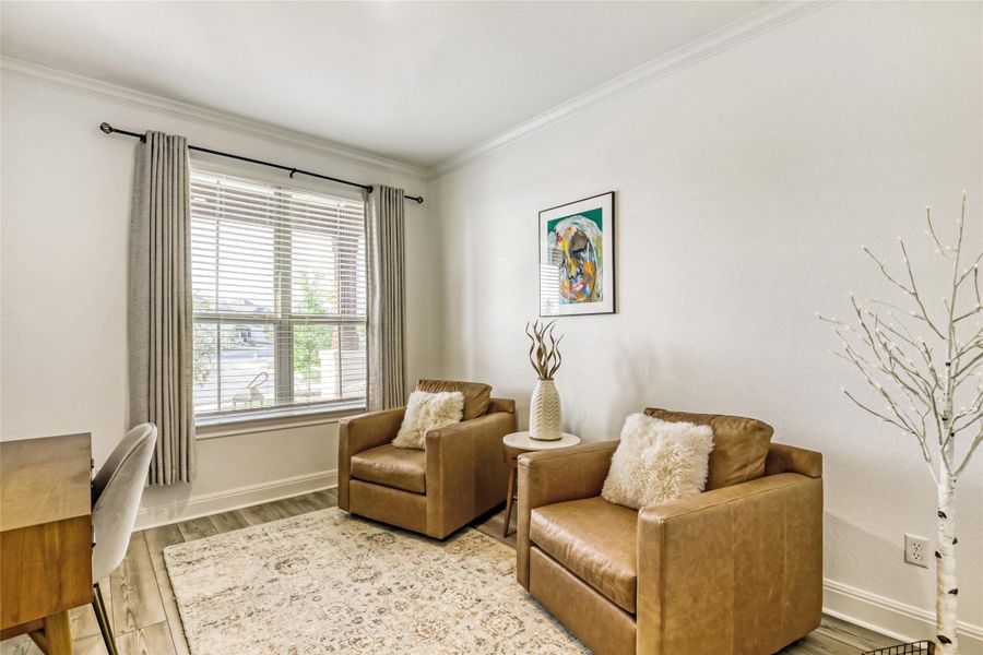 A well-lit sitting area with neutral decor and attractive wood-look flooring invites relaxation. A well-lit sitting area with neutral decor and attractive wood-look flooring invites relaxation.
