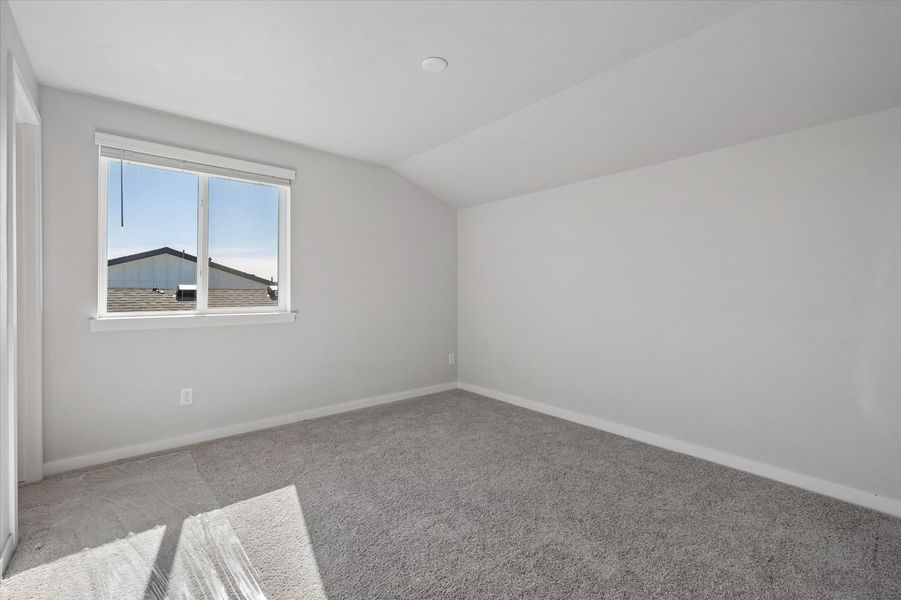 A room with a rug and a window.