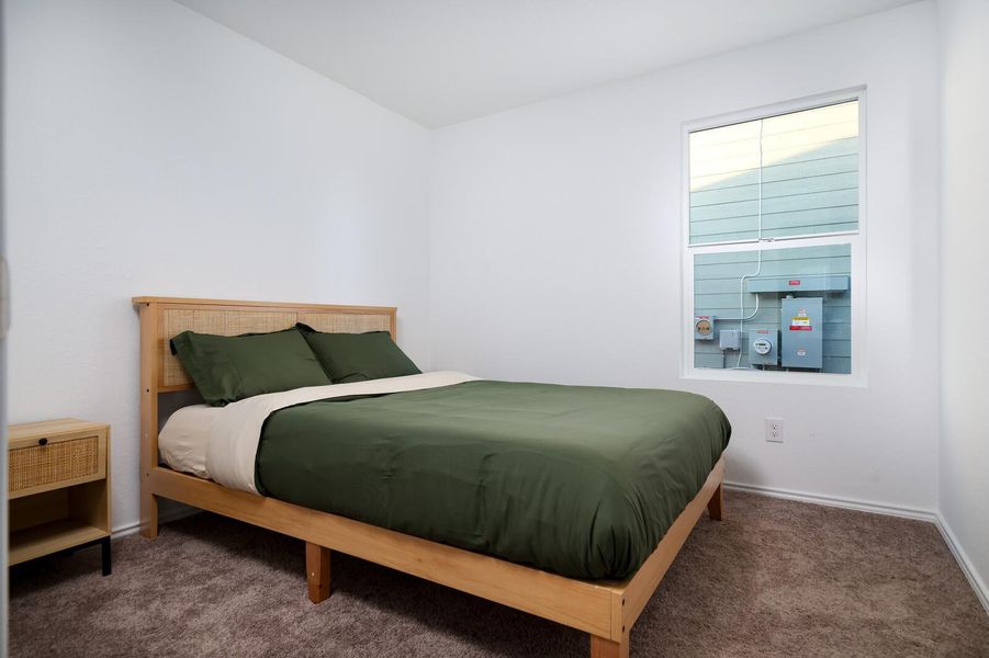 Bedroom with carpet flooring and baseboards Bedroom with carpet flooring and baseboards