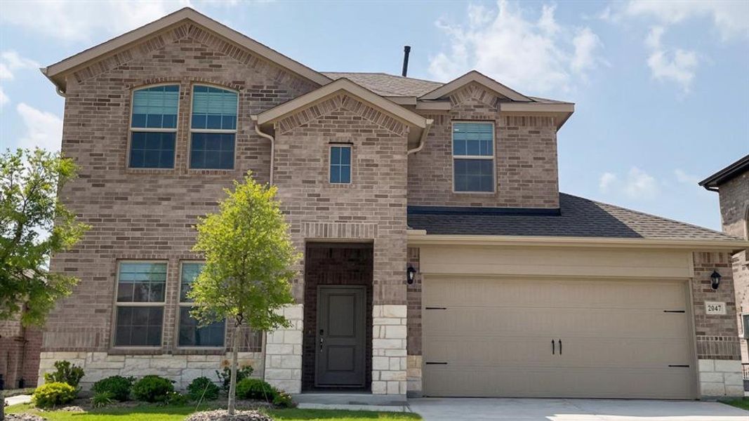 Two-story brick facade with stone accents Two-story brick facade with stone accents