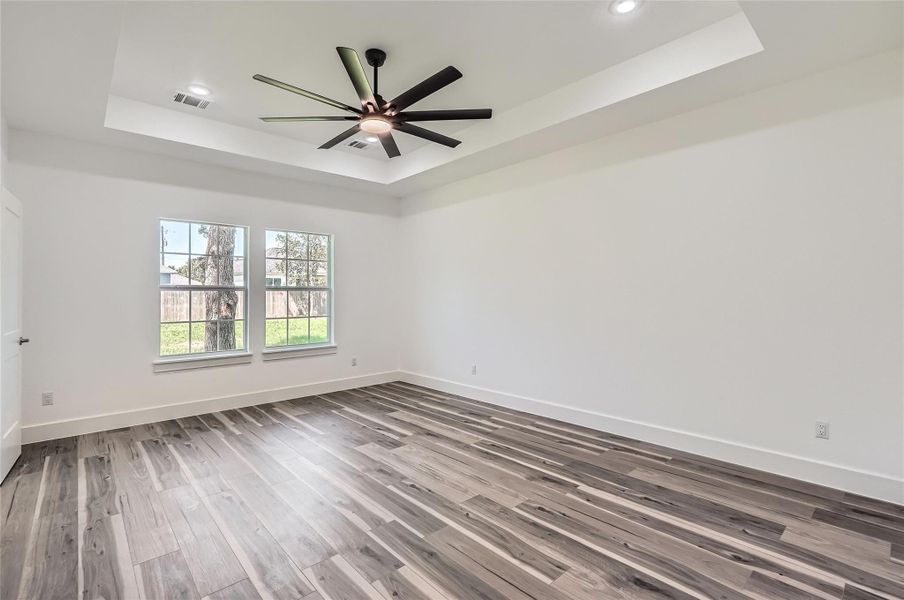 Primary Room with coffered-ceiling, a ceiling fan, and recessed lighting