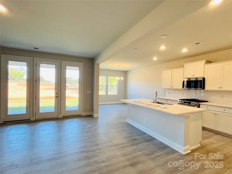 Enjoy all the natural lights with these large windows and door leading to your covered patio!