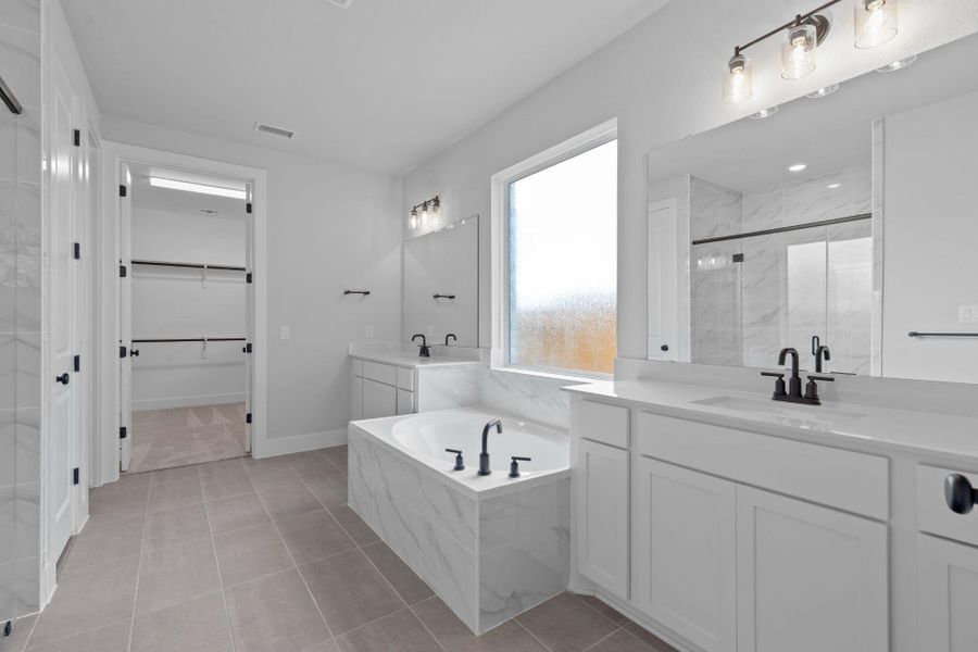 Primary Bath retreat with dual vanities & garden tub - Representative Photo