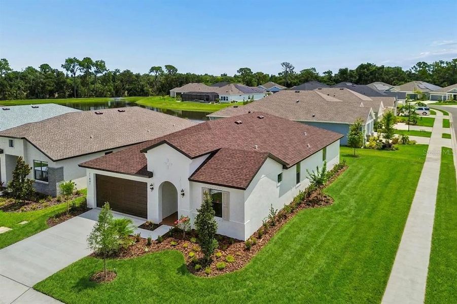 Front exterior of a new home in Isles at Bayview, Parrish, FL, highlighting curb appeal (Image 2). Front exterior of a new home in Isles at Bayview, Parrish, FL, highlighting curb appeal (Image 2).