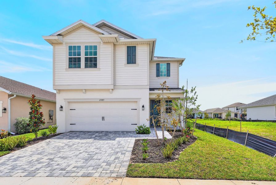 Front exterior of a new home in The Sanctuary – Coastal Collection, Punta Gorda, FL, highlighting curb appeal (Image 2). Front exterior of a new home in The Sanctuary – Coastal Collection, Punta Gorda, FL, highlighting curb appeal (Image 2).