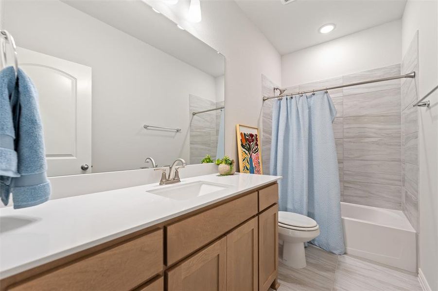 Full bathroom featuring vanity and shower / tub combo with curtain