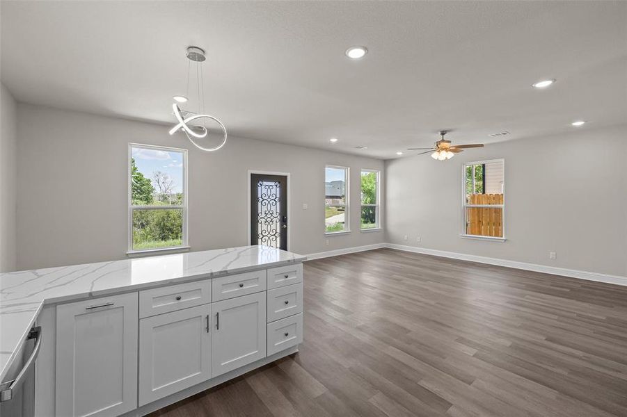 Kitchen featuring dark wood-type flooring, sink, white cabinetry, and stainless steel appliances