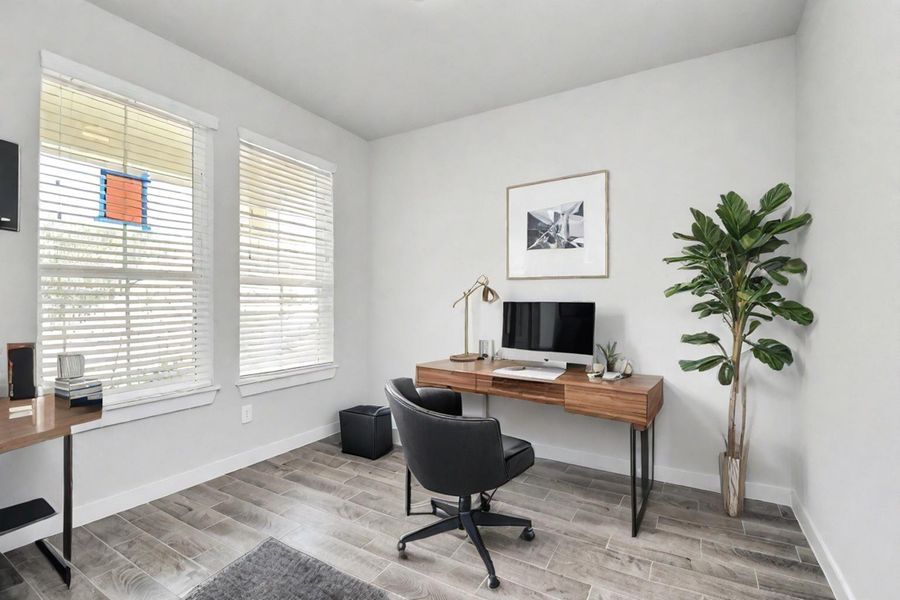 Experience the perfect blend of sophistication and warmth in this home office, boasting elegant wood-look tile flooring and flooded with natural light from expansive windows and French doors. Sample photo of completed home with similar floor plan. Actual colors and selections may vary.
