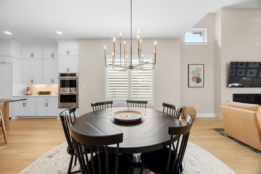 Dining room featuring light wood-style flooring, a chandelier, and recessed lighting