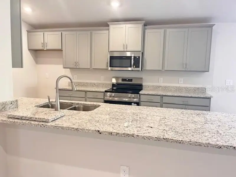 Furnished interior view inside a new home in Abbey Glen, Dade City (Image 3).
