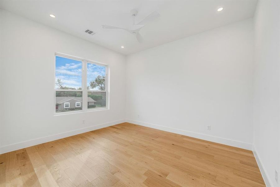 Empty room featuring light wood-style floors, recessed lighting, and a ceiling fan Empty room featuring light wood-style floors, recessed lighting, and a ceiling fan