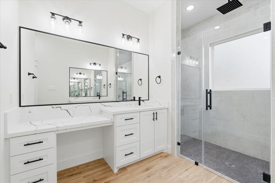 The en-suite bath offers a dedicated vanity area, and a luxurious glass-enclosed shower equipped with soap niches & plenty of shower heads. The en-suite bath offers a dedicated vanity area, and a luxurious glass-enclosed shower equipped with soap niches & plenty of shower heads.