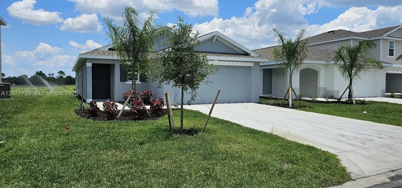 Front exterior of a new home in , Lehigh Acres, FL, highlighting curb appeal (Image 1). Front exterior of a new home in , Lehigh Acres, FL, highlighting curb appeal (Image 1).