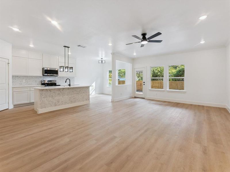 Unfurnished living room featuring light wood-style floors, recessed lighting, and ceiling fan
