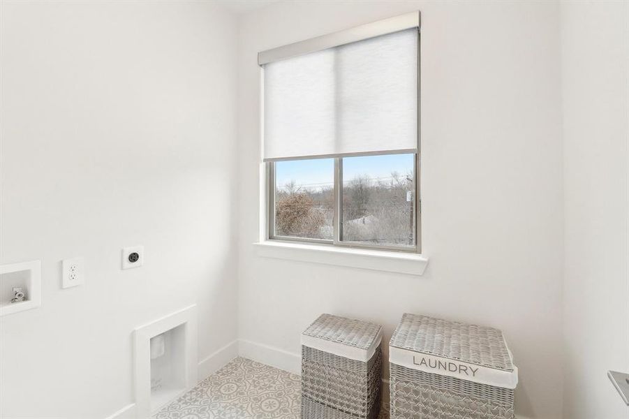 Laundry area conveniently located on 3rd floor by primary and secondary bedrooms. 
 machine, laundry area, hookup for an electric dryer, and baseboards