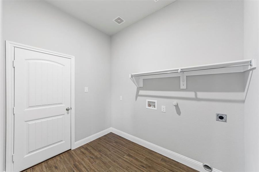 Washroom featuring hookup for an electric dryer, gas dryer hookup, dark wood-type flooring, and washer hookup