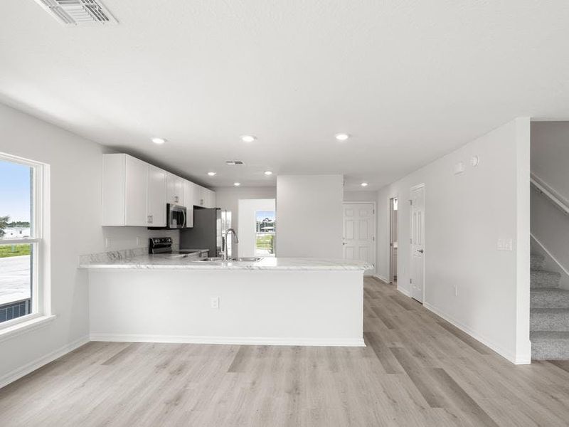 Choose from homes with classic white or warm wood finishes - Isla townhome by Highland Homes