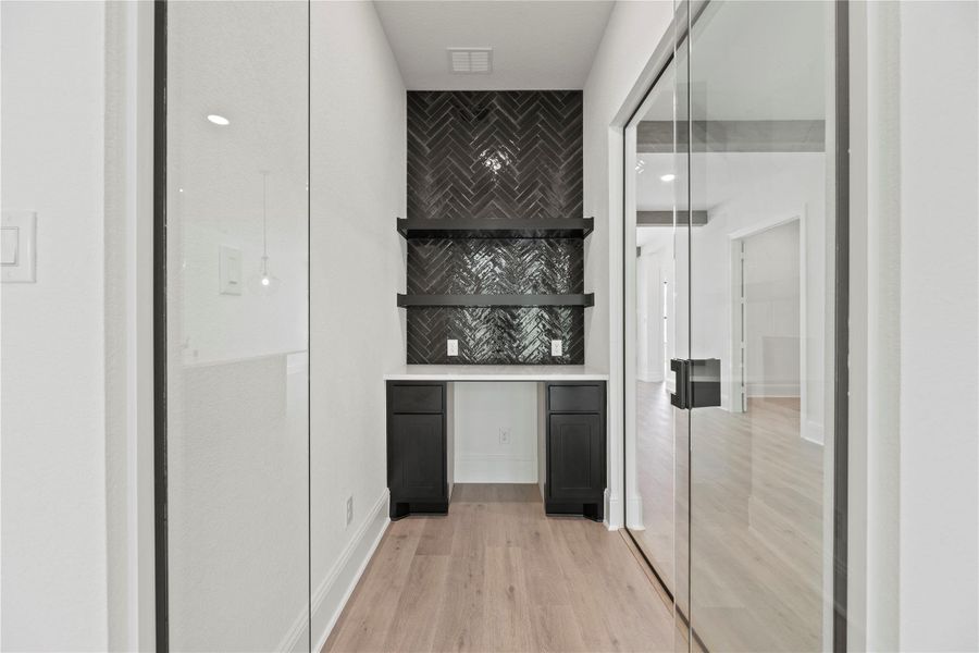 Glass enclosed wine grotto right off the kitchen and living room, perfect for entertaining.