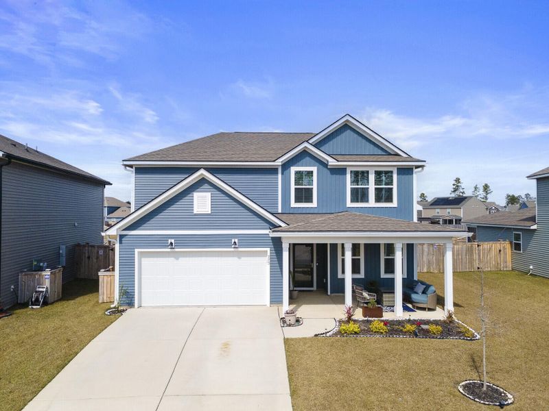 Front exterior of a new home in Sanctuary Cove at Cane Bay, Summerville, SC, highlighting curb appeal (Image 23).
