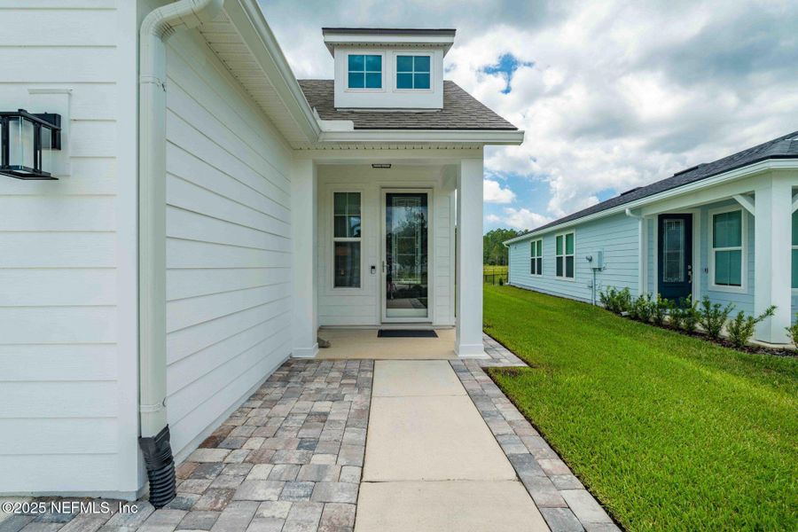Front exterior of a new home in Summer Bay at Grand Oaks, St. Augustine, FL, highlighting curb appeal (Image 22). Front exterior of a new home in Summer Bay at Grand Oaks, St. Augustine, FL, highlighting curb appeal (Image 22).