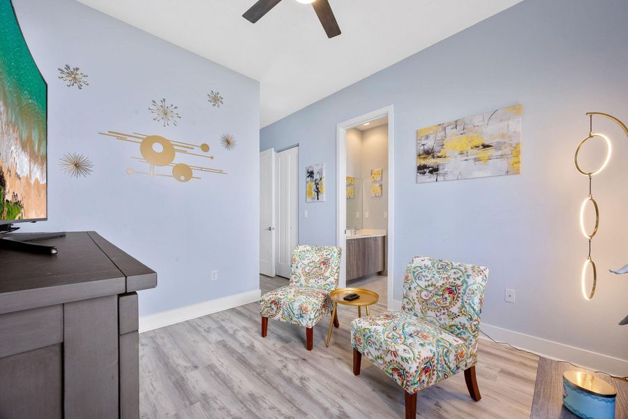 Living area featuring light wood-style floors and ceiling fan