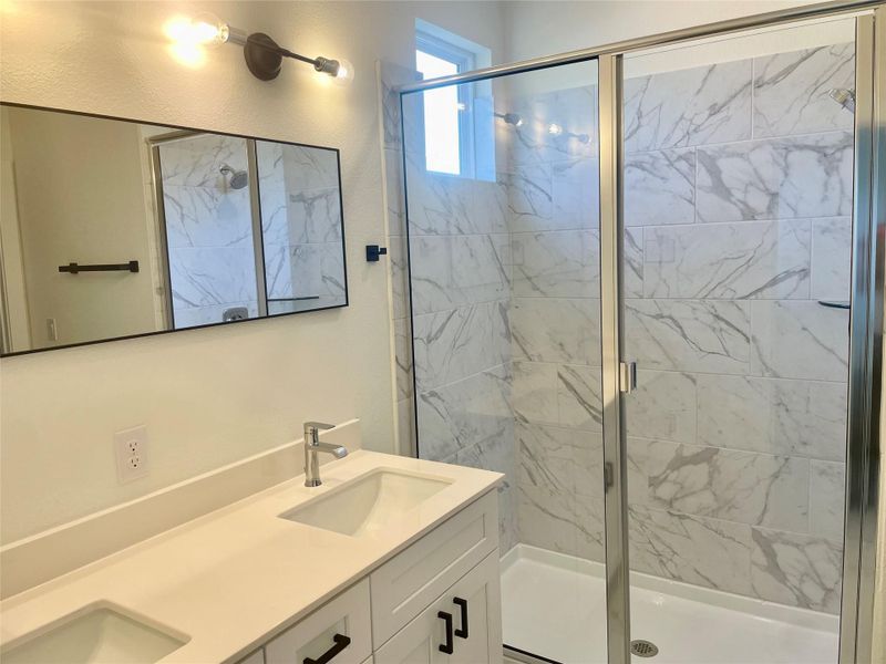 Dual under-mounted sinks at primary bathroom