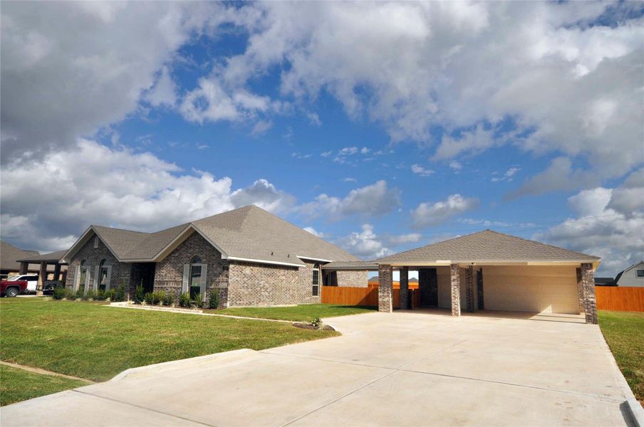 Front exterior of a new home in Pedregal, League City, TX, highlighting curb appeal (Image 23).