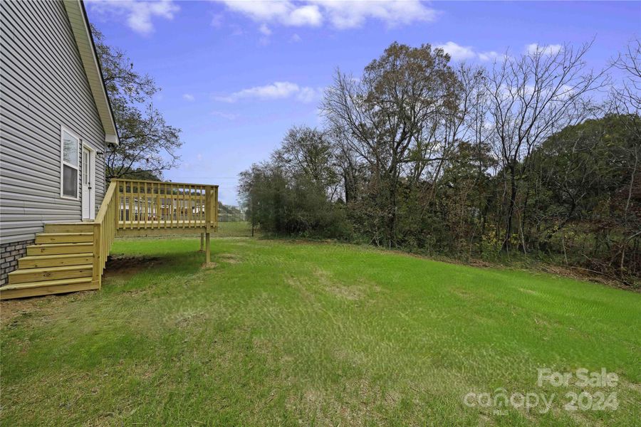 Great outdoor living with Deck on back of home.