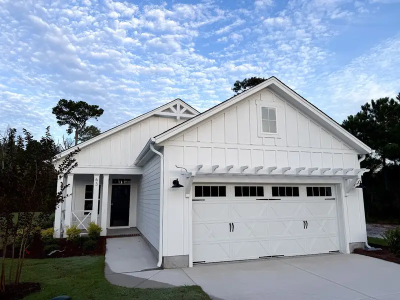Front exterior of a new home in Songbird, Hampstead, NC, highlighting curb appeal (Image 1). Front exterior of a new home in Songbird, Hampstead, NC, highlighting curb appeal (Image 1).