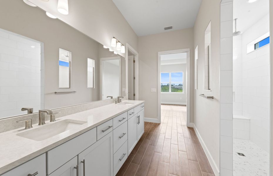 Owner's bathroom with dual-sink vanity and spacious shower