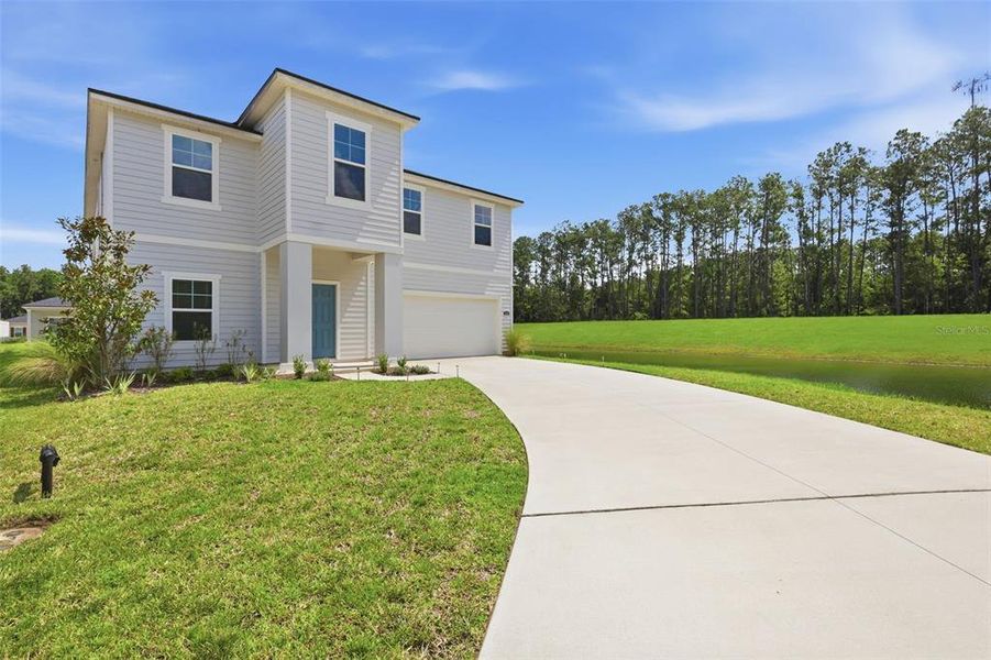 Front exterior of a new home in Dunns Crossing, Jacksonville, FL, highlighting curb appeal (Image 25). Front exterior of a new home in Dunns Crossing, Jacksonville, FL, highlighting curb appeal (Image 25).