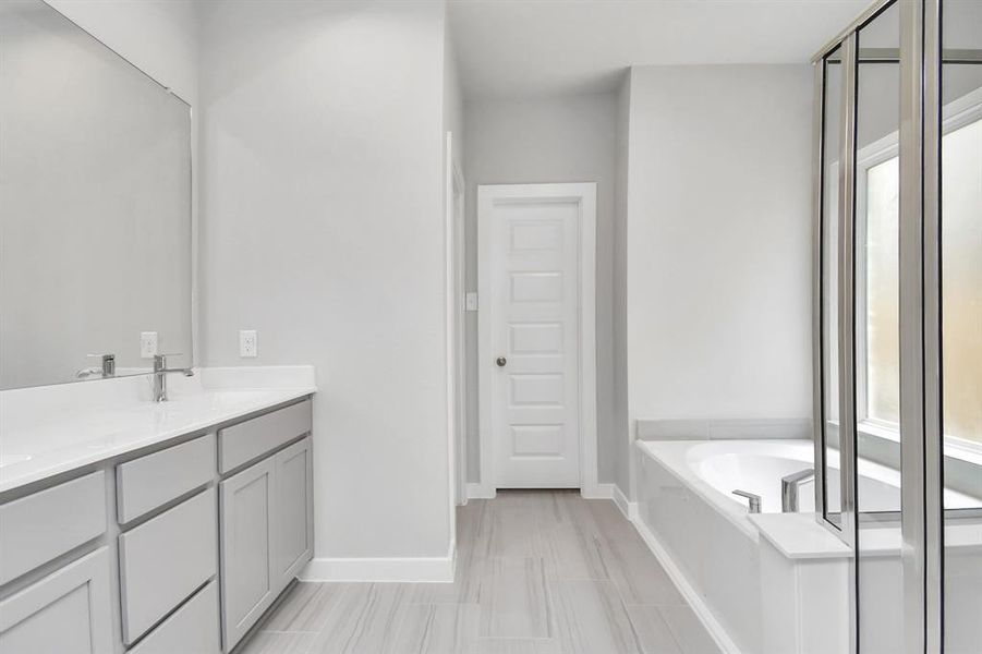 Escape to a spa-like oasis in this primary bathroom. Sample photo of completed home with similar floor plan. Actual colors and selections may vary.