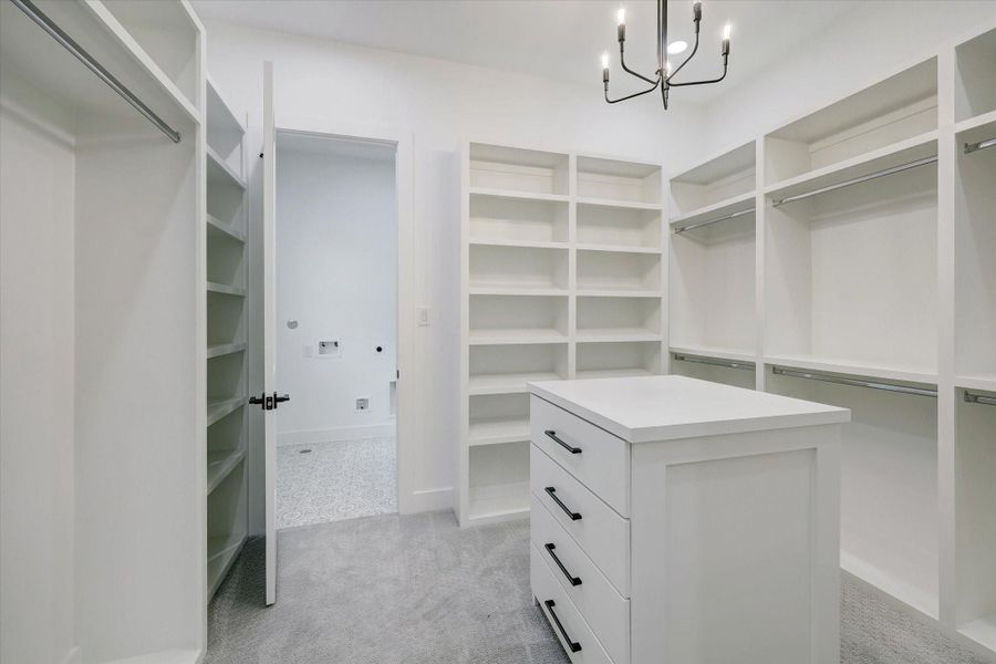 Walk-in Closet (1/2) – Thoughtfully designed with custom built-ins and a center island, offering exceptional storage, organization, and boutique-style functionality.