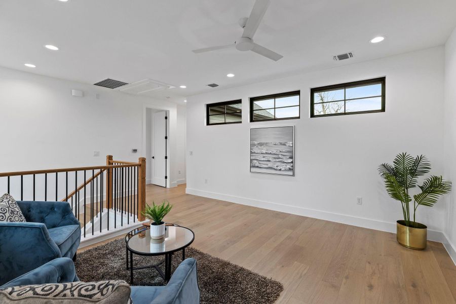 Living area featuring attic access, light wood finished floors, ceiling fan, recessed lighting, and baseboards