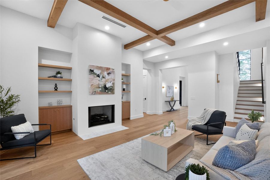 Exposed beams and a modern fireplace elevate this inviting living space.