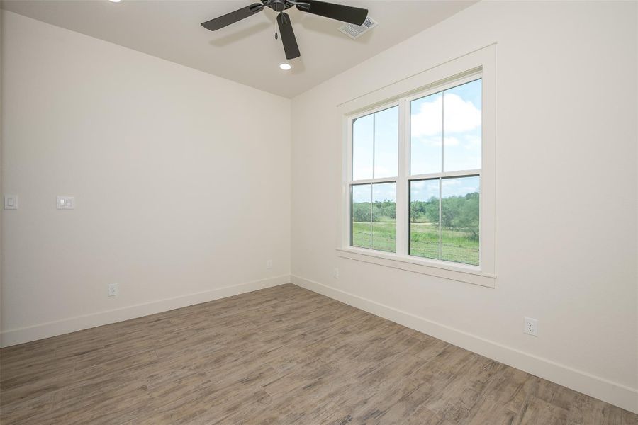 Empty room featuring wood finished floors and recessed lighting