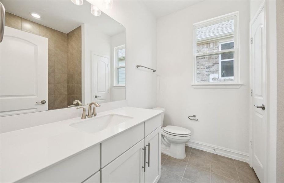 Upgraded secondary bath with elegant finishes  *Real home pictured